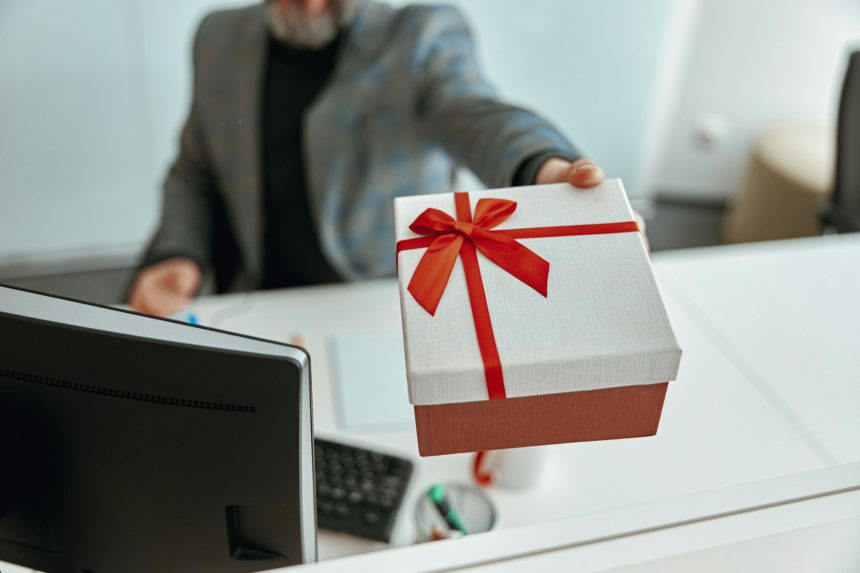 Man demonstrating present gift at the table