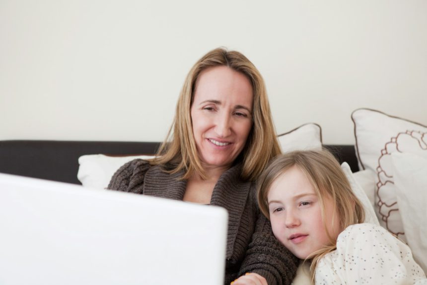 Mother and daughter using laptop